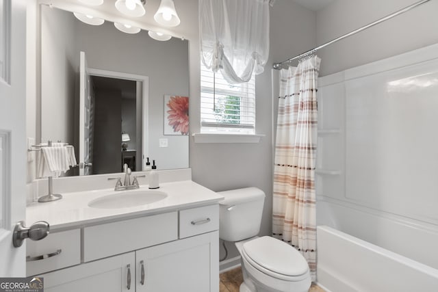 full bathroom with vanity, shower / tub combo, and toilet