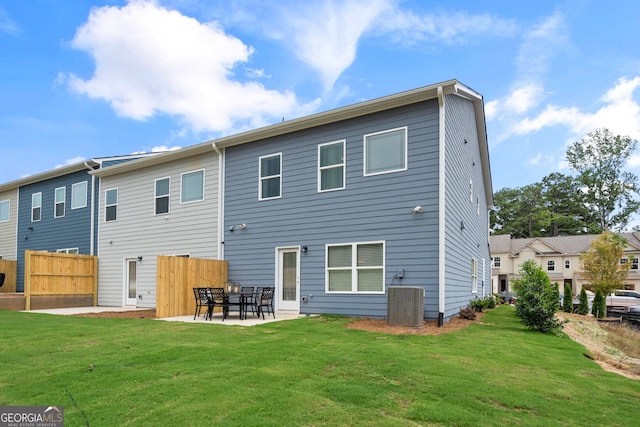 rear view of house with a lawn, central air condition unit, and a patio area