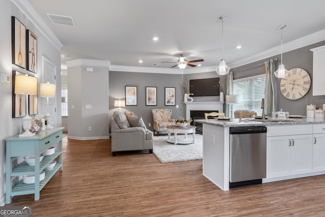 kitchen featuring hanging light fixtures, dishwasher, light stone countertops, and white cabinets