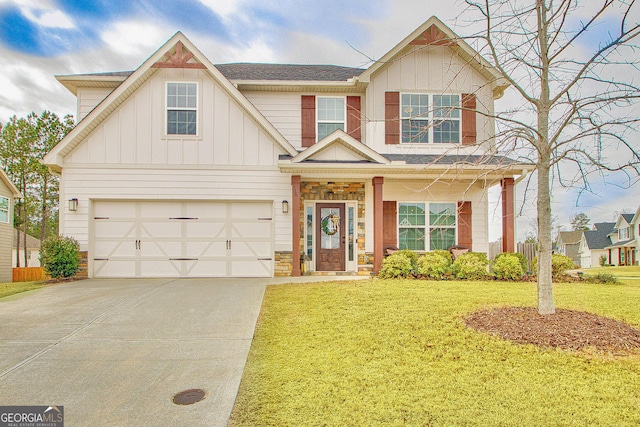 view of front of house with a front lawn, board and batten siding, and concrete driveway