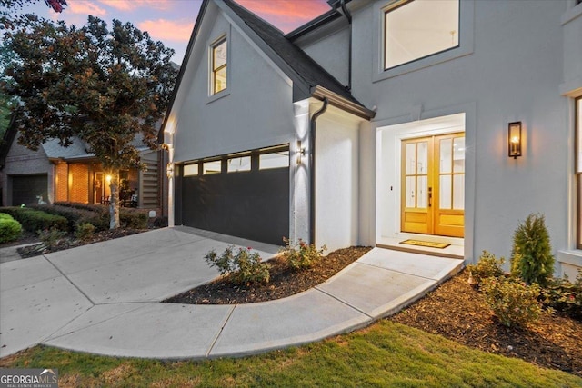 view of front facade with a garage and french doors