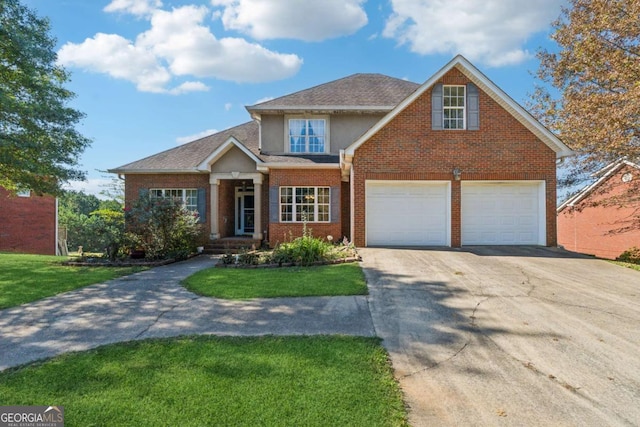 view of front facade with a garage and a front lawn