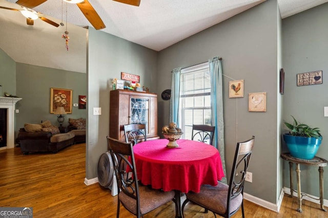 dining area featuring hardwood / wood-style floors and ceiling fan