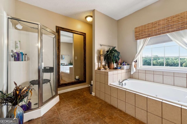 bathroom with tile patterned floors, plus walk in shower, and a textured ceiling