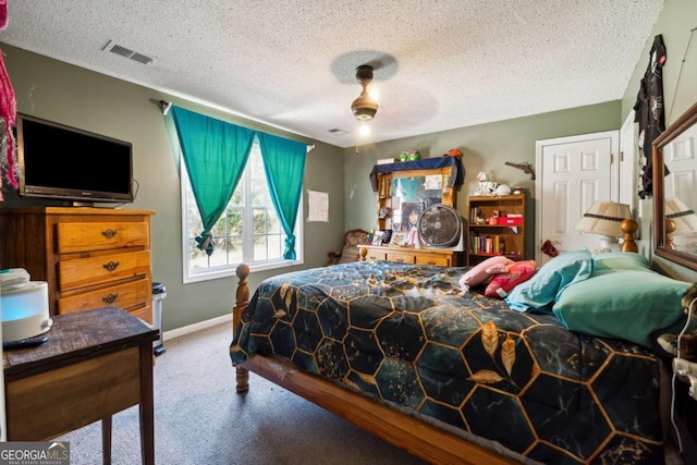 bedroom with ceiling fan, a textured ceiling, and carpet flooring