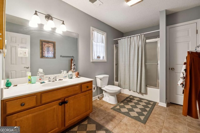 full bathroom featuring shower / tub combo with curtain, vanity, toilet, tile patterned floors, and a textured ceiling