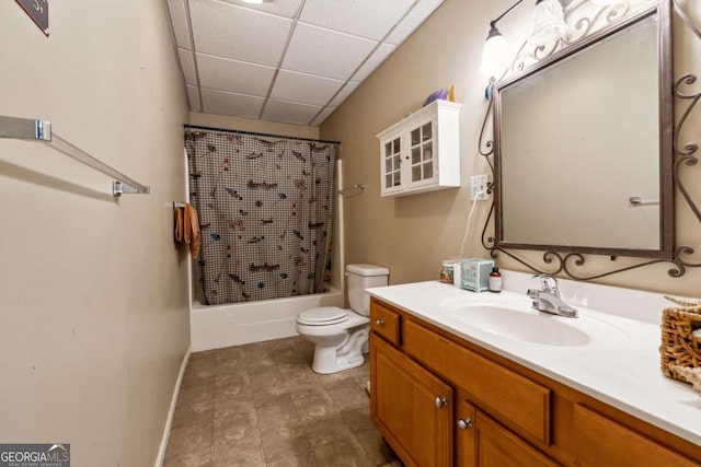 full bathroom featuring toilet, vanity, shower / bathtub combination with curtain, and a drop ceiling