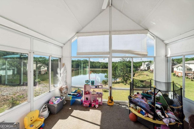 sunroom / solarium with vaulted ceiling and a water view