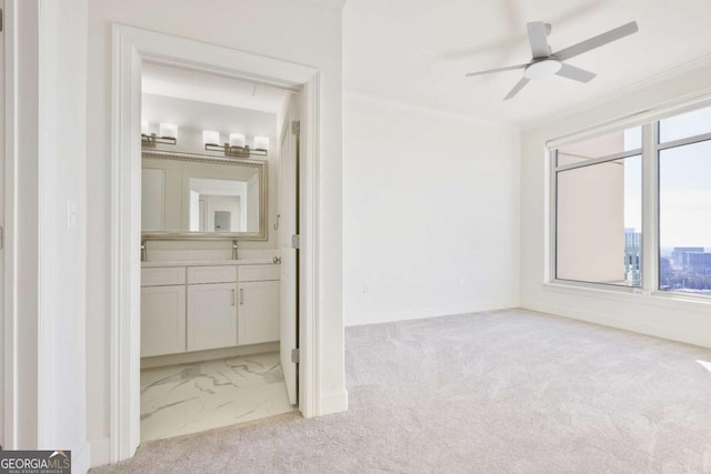 carpeted empty room with ceiling fan and ornamental molding