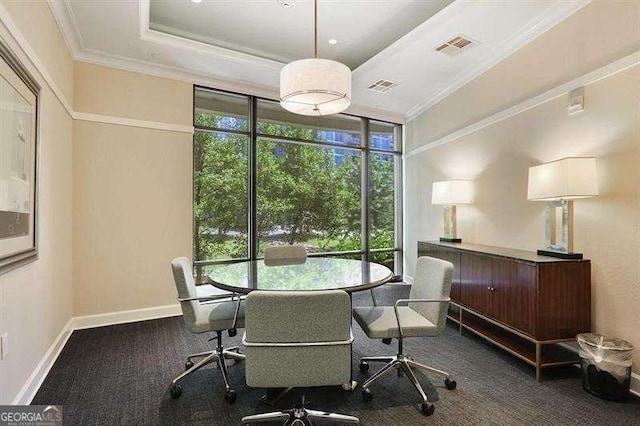 dining space featuring a tray ceiling, a wall of windows, and ornamental molding