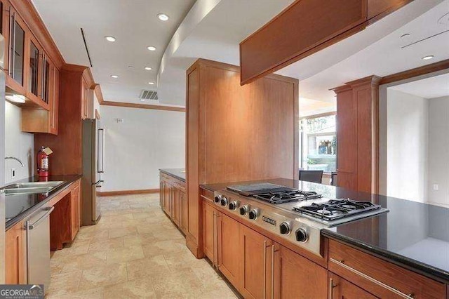 kitchen with ornamental molding, stainless steel appliances, and sink