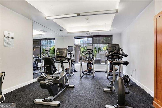 gym with a tray ceiling