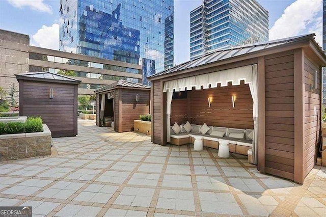 view of patio with a storage unit and an outdoor hangout area