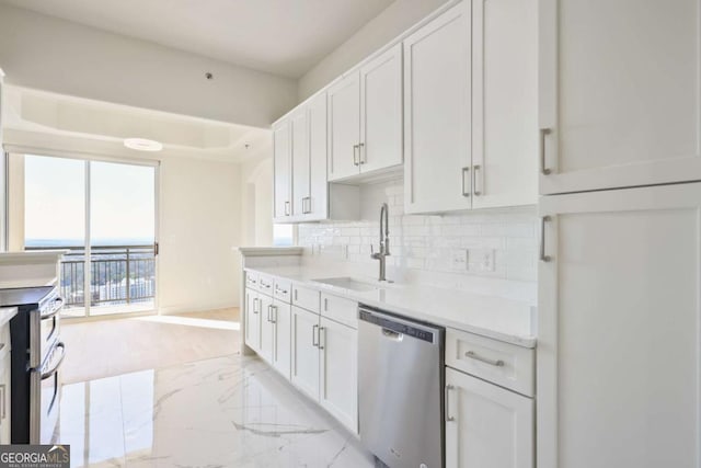 kitchen featuring white cabinetry, sink, backsplash, and stainless steel appliances