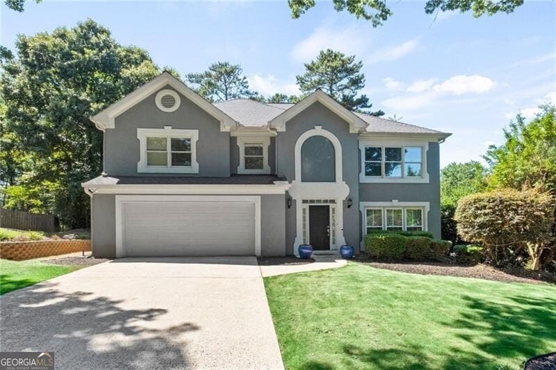 view of front of house with a garage and a front yard