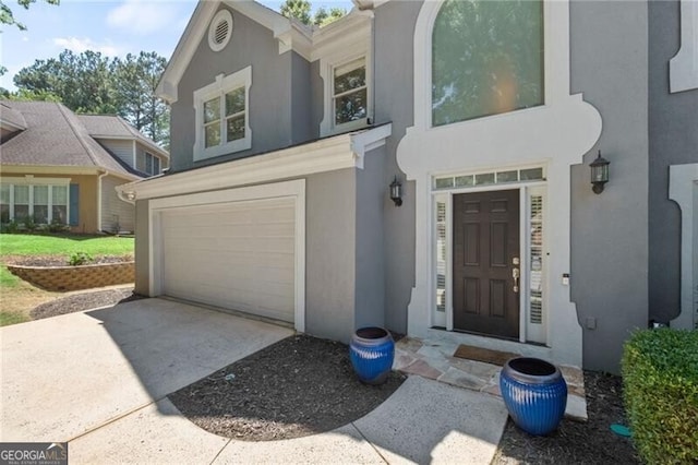 doorway to property with a garage