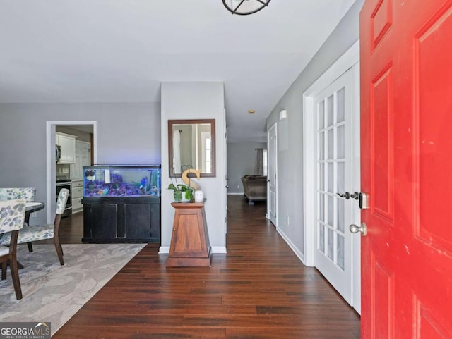 foyer with dark wood-type flooring and french doors