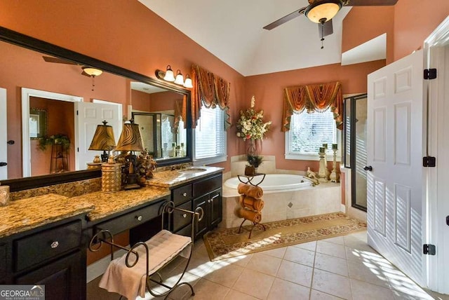 bathroom featuring lofted ceiling, tile patterned flooring, vanity, and a wealth of natural light