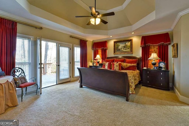 carpeted bedroom with crown molding, access to exterior, a tray ceiling, and ceiling fan