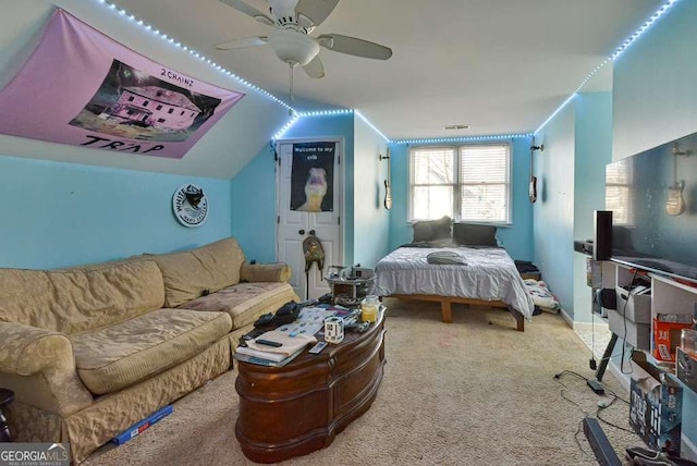 bedroom with ceiling fan, carpet flooring, and vaulted ceiling