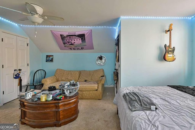 bedroom with light carpet, vaulted ceiling, a closet, and ceiling fan