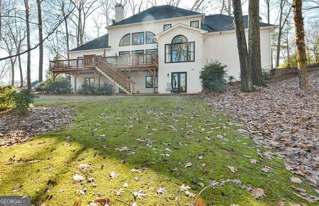 back of house featuring a wooden deck and a yard