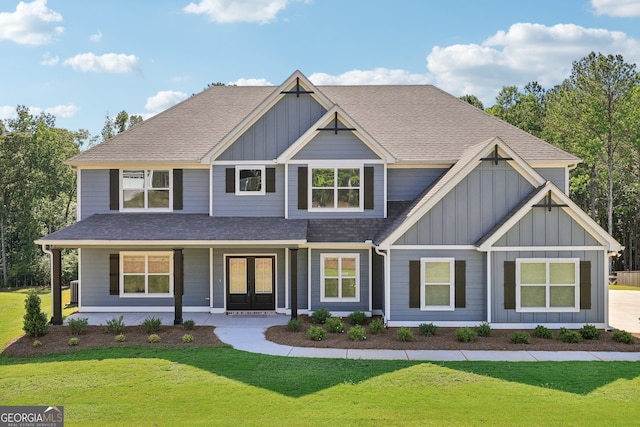 craftsman house with french doors, a porch, and a front lawn