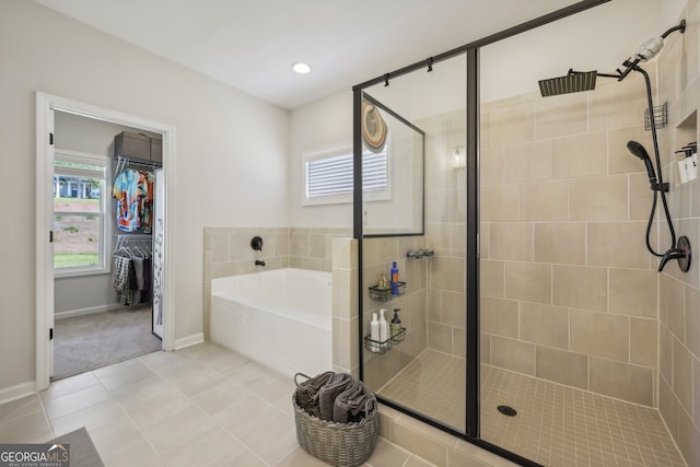 bathroom featuring shower with separate bathtub and tile patterned flooring