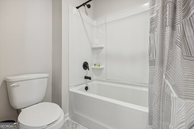 bathroom with shower / tub combo and toilet