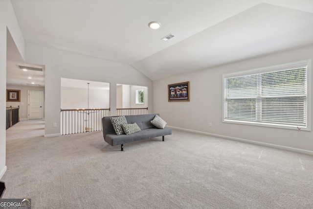 living area with lofted ceiling and light carpet