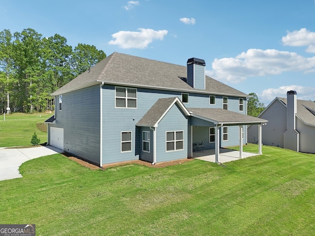 rear view of property featuring a yard and a patio area