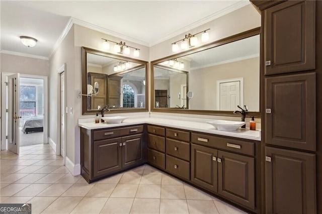 bathroom with crown molding, vanity, and tile patterned flooring