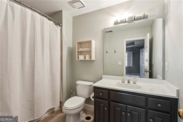 bathroom featuring vanity and toilet