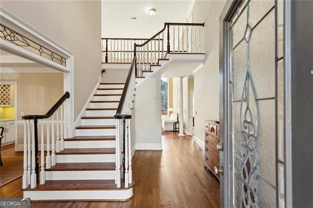 entrance foyer featuring dark hardwood / wood-style flooring and a high ceiling