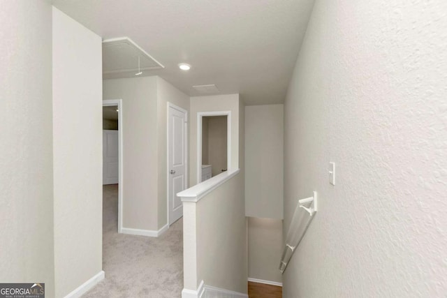 hallway with light colored carpet