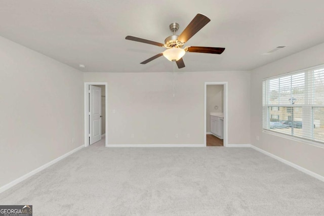 unfurnished room featuring light colored carpet and ceiling fan