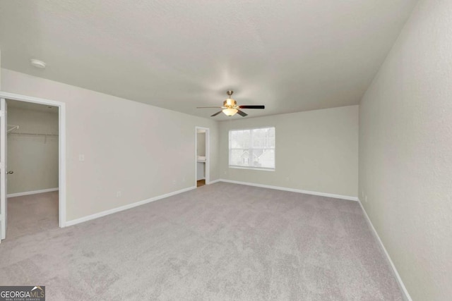 unfurnished room with light carpet and ceiling fan