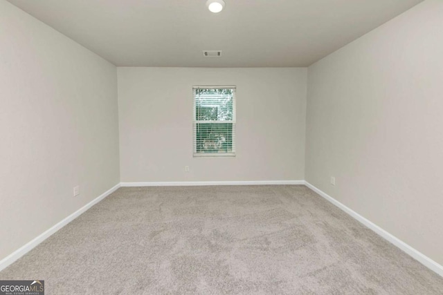 empty room featuring light colored carpet