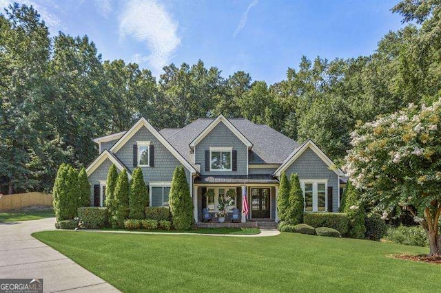 craftsman house featuring a porch and a front lawn