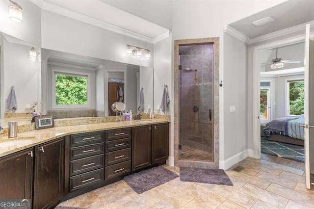 bathroom with vanity, crown molding, a shower with shower door, and ceiling fan