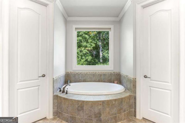 bathroom featuring a relaxing tiled tub and ornamental molding