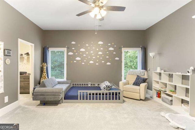 sitting room featuring carpet and ceiling fan