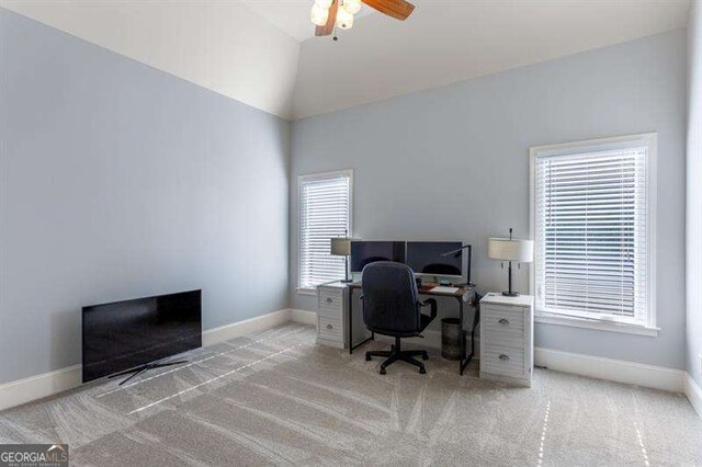 carpeted office featuring vaulted ceiling and ceiling fan