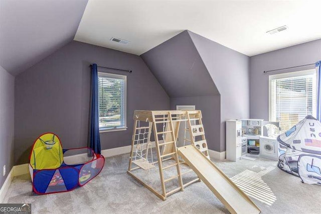 game room with vaulted ceiling, carpet floors, and a wealth of natural light