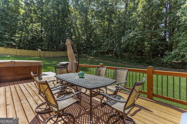 wooden deck with a hot tub and a yard