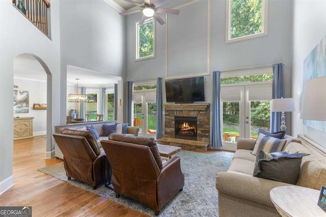 living room with a healthy amount of sunlight, a fireplace, and light hardwood / wood-style flooring