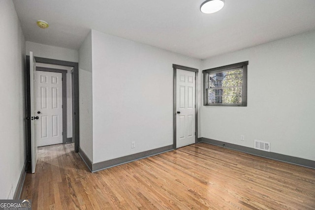 spare room with hardwood / wood-style flooring