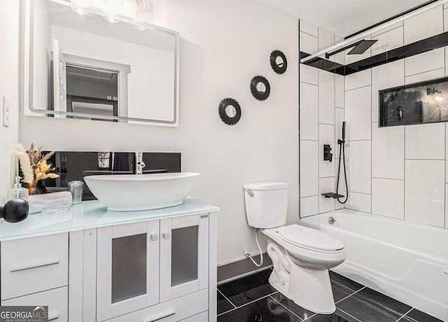 full bathroom with vanity, tiled shower / bath, tile patterned floors, and toilet