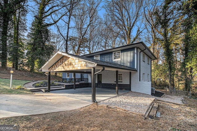 view of front of house with a carport and central air condition unit