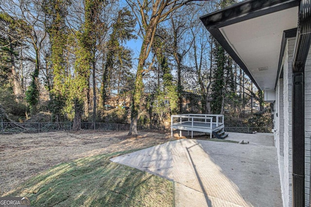 view of yard featuring a patio area and a deck